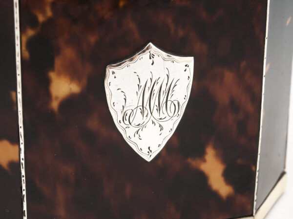 Close up of the shield shaped initial plaque