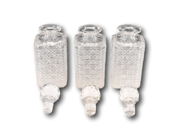 View of the three hand cut hobnail decanters with the faceted stoppers removed