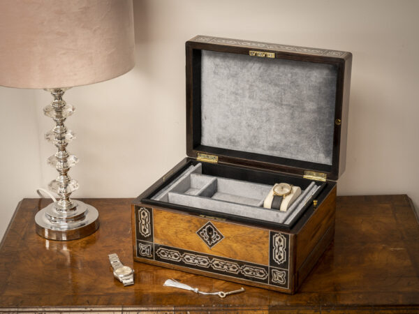 Rosewood and mother of pearl jewellery box on sideboard