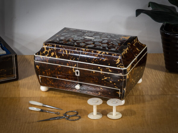 tortoiseshell and mother of pearl sewing box on table