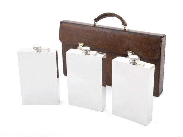 Bootlegger Case giant hip flasks next to case