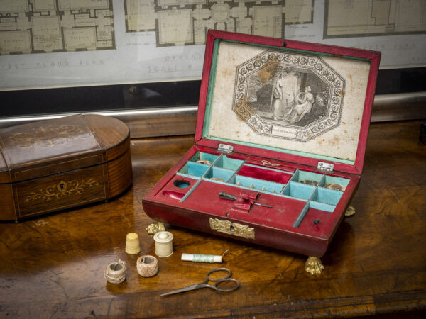 antique red leather sewing box on display on a table