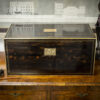 Coromandel writing box writing on display on a set of drawers