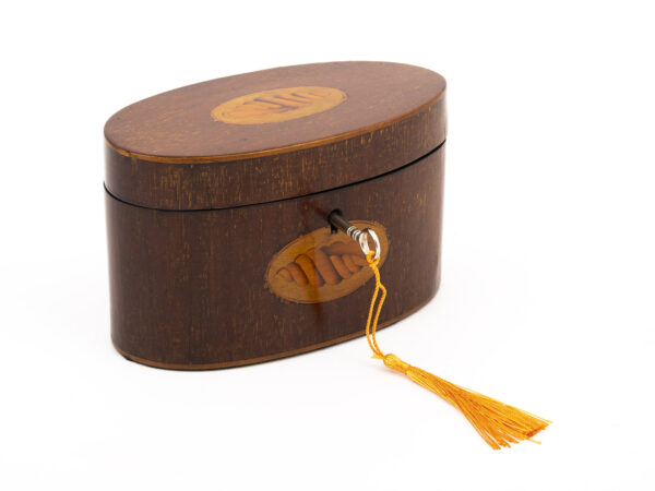 oval tea caddy with tasselled key