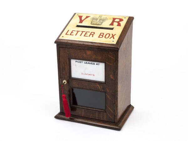 Featured here is an Antique Country House letter box by Army & Navy. Designed beautifully and made from English Oak, this lovely Antique Country House Post Box features a large brass letter slot with red enamelled lettering. This elegant antique post box is adorned with a ceramic panel in the door for marking the time that the post is collected, and a plaque on the back of the main door with an inscription that reads, “Army & Navy C. S. L. Makers”. In addition to the Country House Letter Box’s decorative appeal, it also offers a fully functioning lock and a tasselled key so you can secure your own letters and documents, making this both a functional and luxury display piece at the same time.