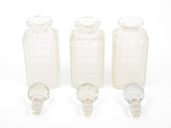 three antique decanters with stoppers removed