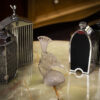 Rene Lalique Tete De Paon Car Mascot in a collectors decorative setting