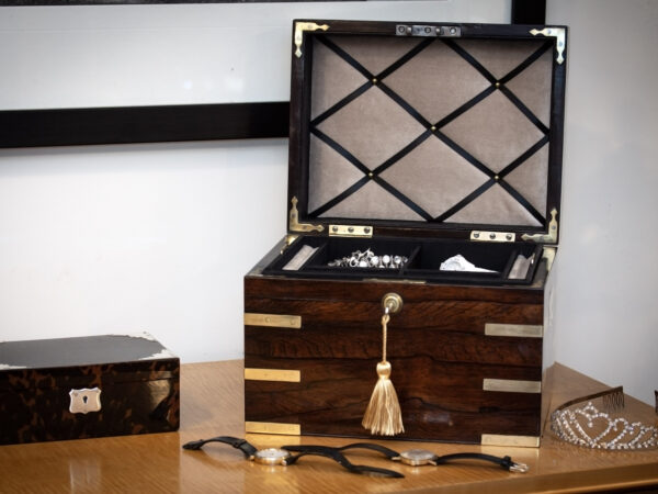 Rosewood Jewellery box in a decorative collectors setting for scale