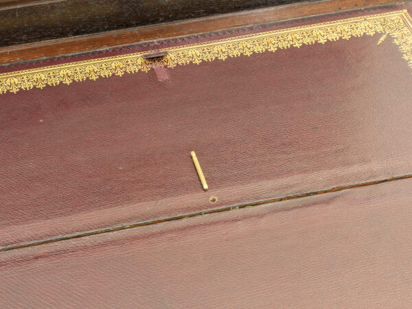 Close up of the brass pin just above the first secret compartment locator