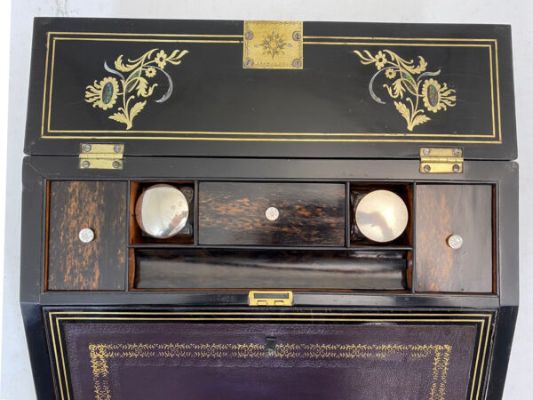 Inside of the Austin of Dublin Coromandel and Sandalwood Writing Slope showing the storage compartments and inkwell housing