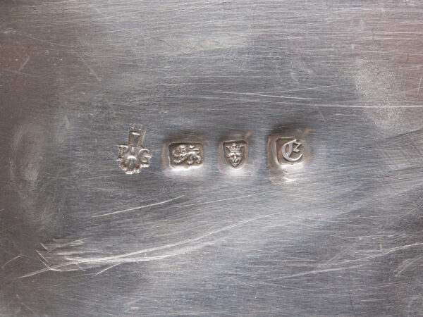 Close up of the sterling silver hallmarks on the bottom of the caddies for London Pierre gillois