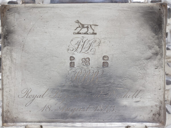 Close up of the crest, hallmarks and engraved writing to the base