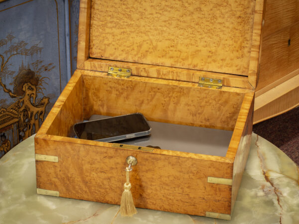 Overview of the Birdseye Maple Jewellery Box in a decorative setting with a laptop and phone placed inside