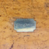 Close up of the initial plaque on the lid