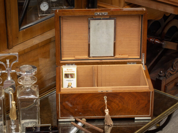 Overview of the Dunhill Humidor with the lid up in a decorative collectors setting