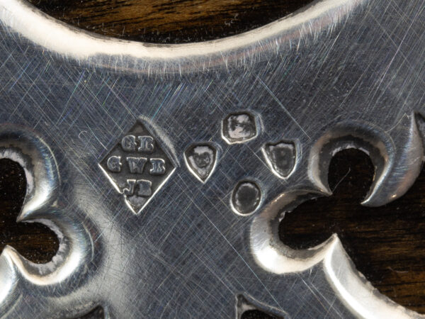 Close up of the sterling silver George Betjemann London 1877 Hallmarks
