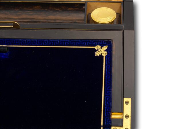 Close up of the gold tooling, greek key and fleur-de-lis decoration