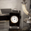 Front overview of the Tortoiseshell Carriage Clock in a decorative collectors setting
