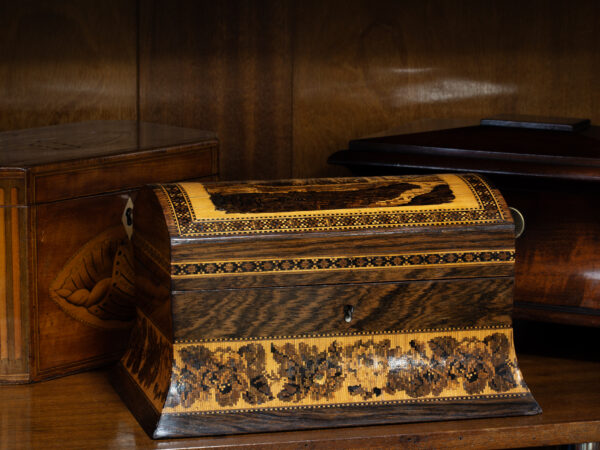 Front overview of the Tunbridge Ware Tea Caddy in a decorative collectors setting
