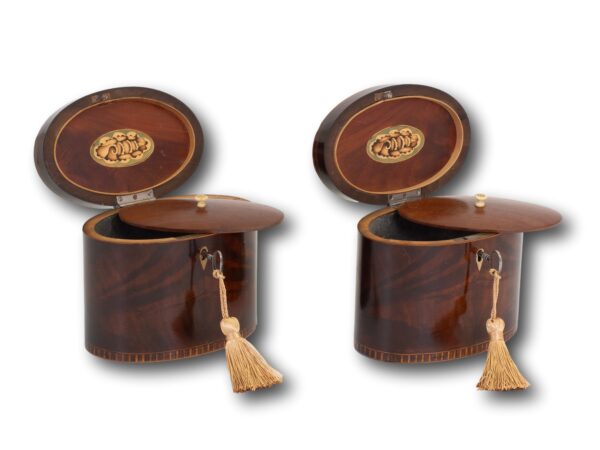 Front overview of the Georgian Pair of Mahogany Tea Caddies with the keys inserted lids up showing the floating lids