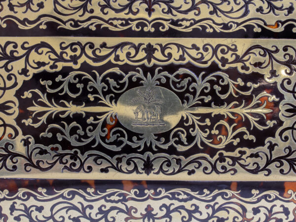 Close up of the family crest engraved into the lid