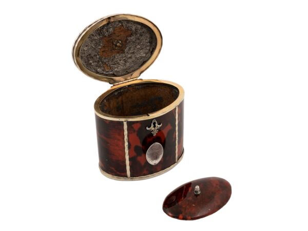 Front overview of the Silver Gilt Oval Red Tortoiseshell Tea Caddy with the lid open and compartment lid removed