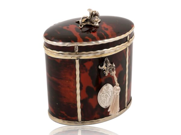 Front overview of the Silver Gilt Oval Red Tortoiseshell Tea Caddy with the key fitted