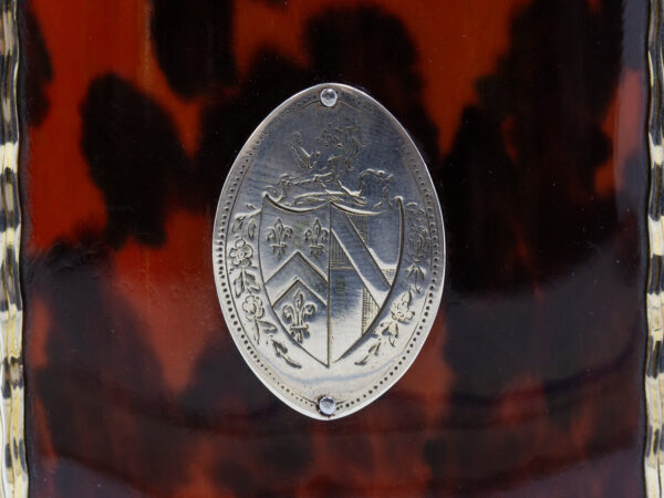 Close up of the family crest on the Silver Gilt Oval Red Tortoiseshell Tea Caddy
