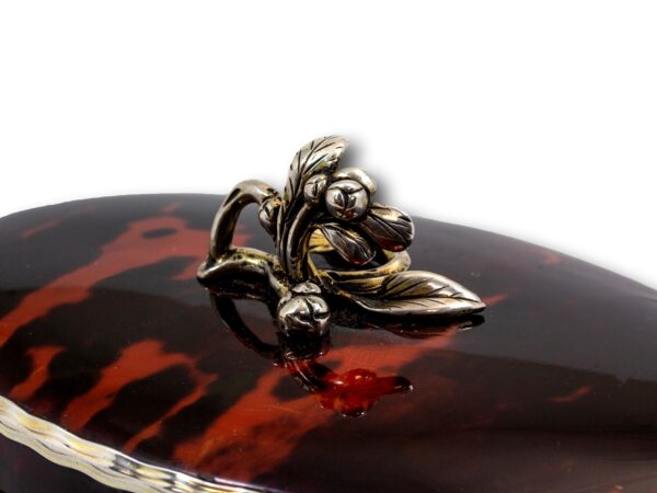 Close up of the tea leaf finial on the Silver Gilt Oval Red Tortoiseshell Tea Caddy