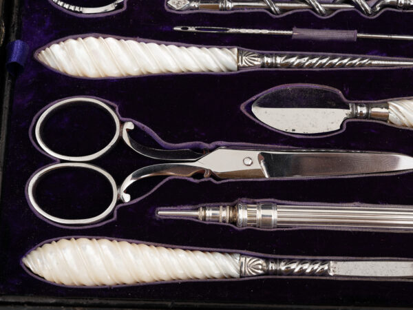 Close up of the mother of pearl tools inside the Burr Walnut and Silver Mechanical Vanity Box Royal Connection