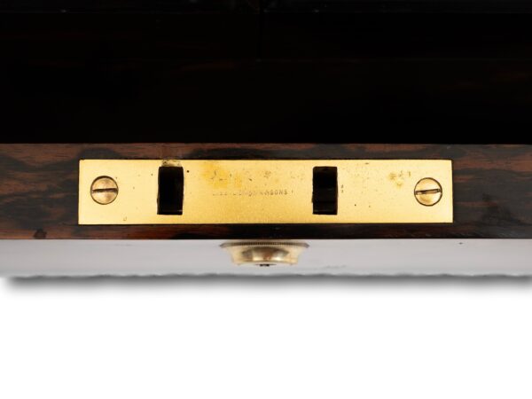 Close up of the George betjemann and sons lockplate mark inside the Burr Walnut and Silver Mechanical Vanity Box Royal Connection