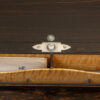 Close up of the compartment push button from the Coromandel Silver Mounted Writing Box Betjemann